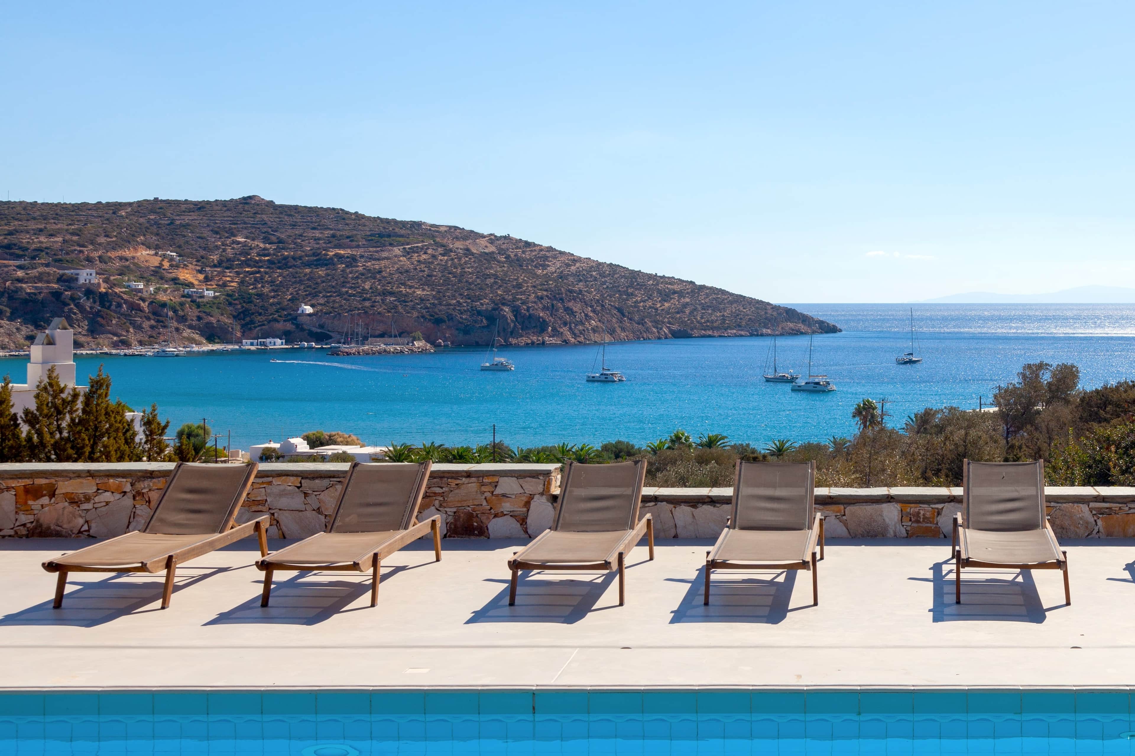 Sun loungers above the turquoise Platis Gialos bay
