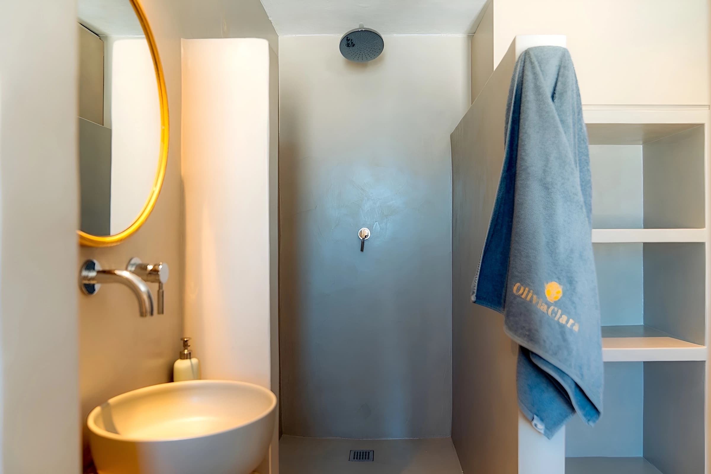 The pool bathroom's walk-in rain shower and open shelves