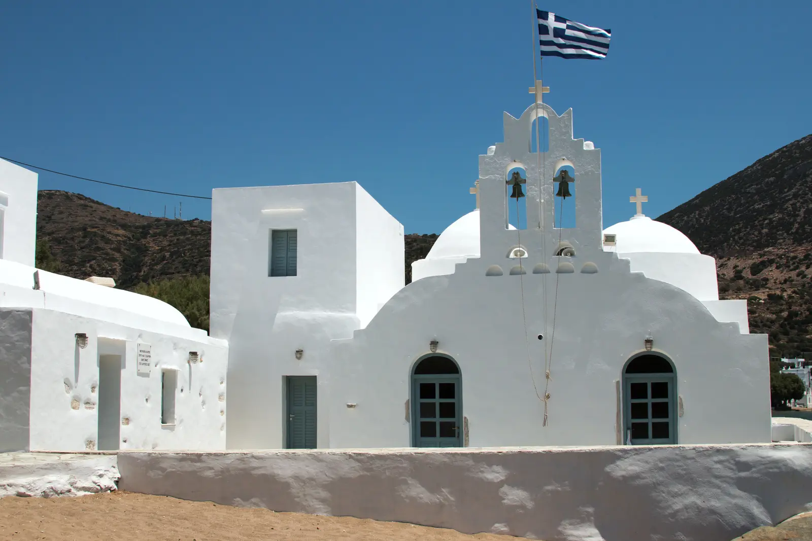The bell facade of the Taxiarchis monastery on the sand at Vathi, Sifnos