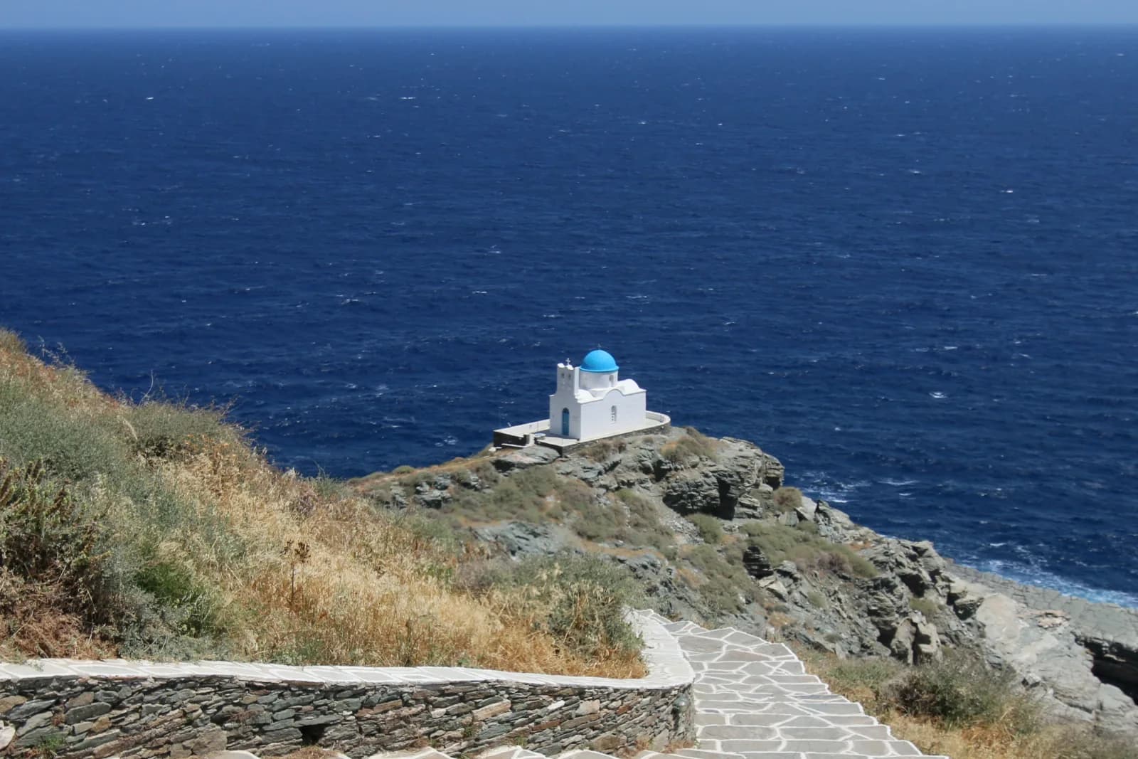 A flagstone footpath winding down the cliffs to the Seven Martyrs chapel below Kastro, Sifnos