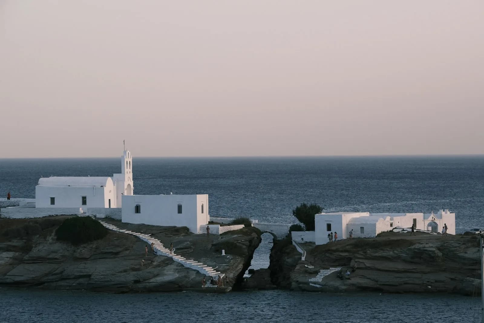 The Chrysopigi monastery on its rocky spit at dusk, Sifnos, with the sea either side of the causeway