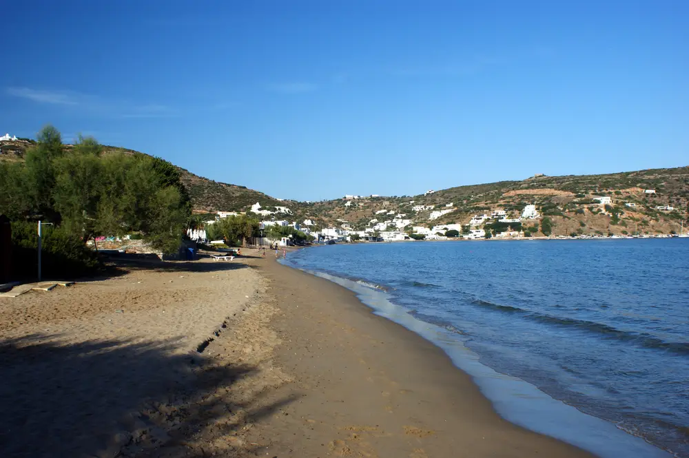 The full sweep of Platis Gialos beach, Sifnos, seen from the waterline at one end of the bay